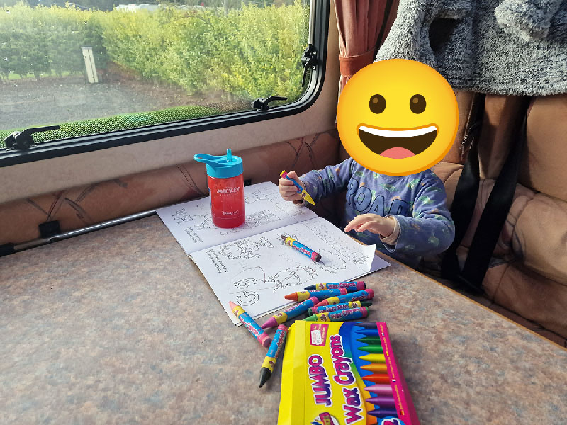 A photo of my son at two years old coloring in our motorhome.